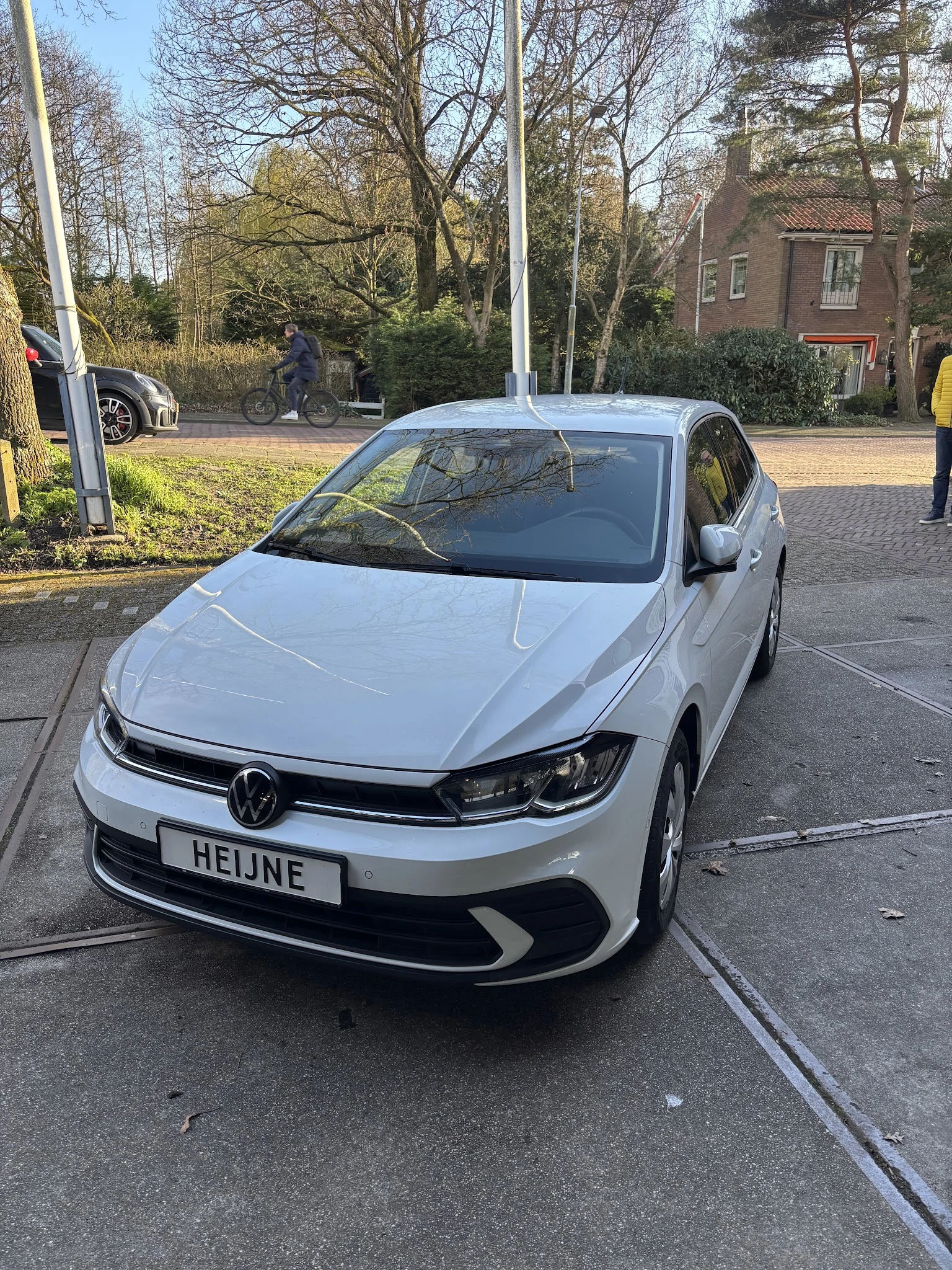 Witte Volkswagen Golf geparkeerd op straat met kentekenplaat 'HEIJNE'
