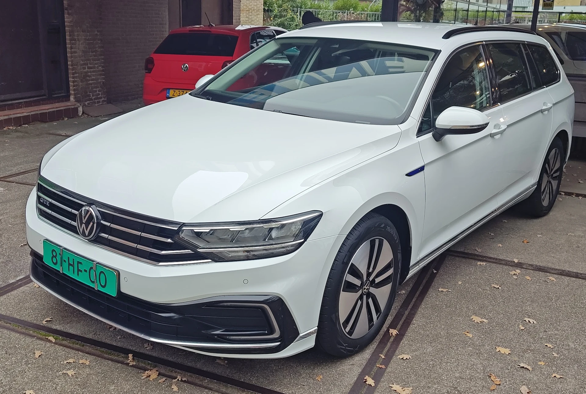 Witte Volkswagen Passat stationwagen geparkeerd buiten, met groene nummerplaat zichtbaar
