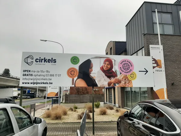 Gevel van kringloopwinkel Cirkels met groot uithangbord, openingstijden en contactgegevens zichtbaar