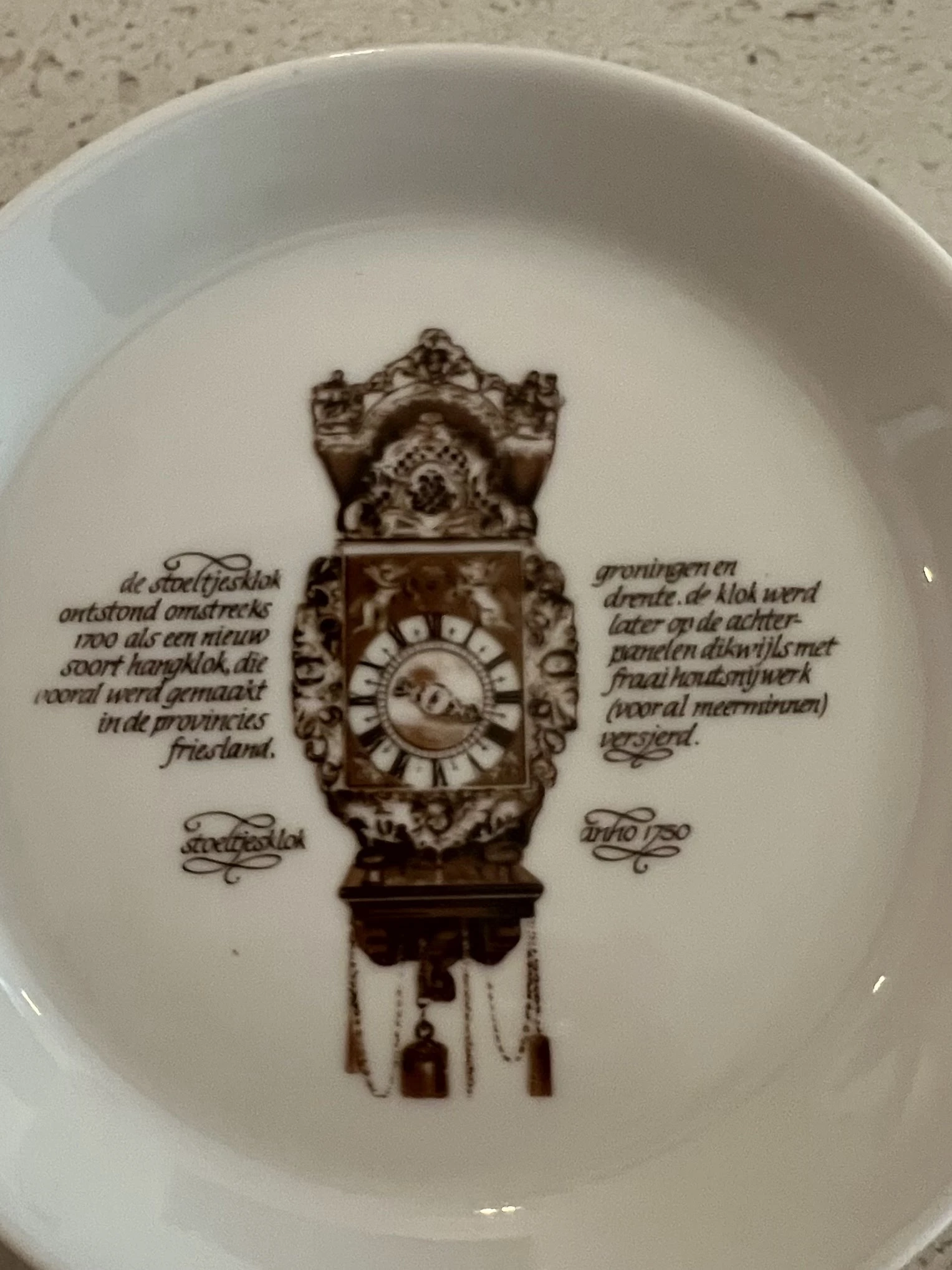 Decoratief bord met afbeelding van een antieke staande klok met tekst in het Nederlands