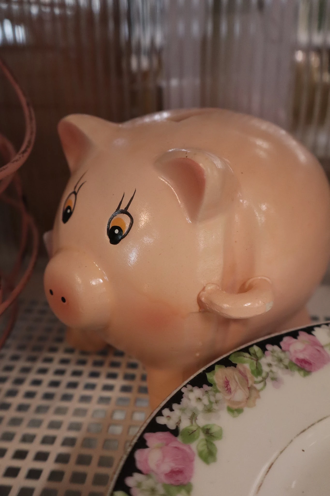 Close-up van een roze spaarvarken met getekende ogen en wimpers