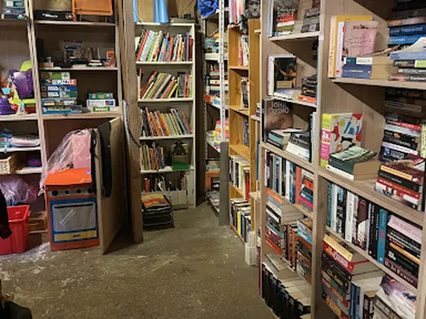 Boekenrekken en stellingen vol tweedehands boeken in een kringloopwinkel