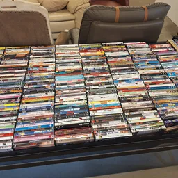Grote collectie dvd's en blu-rays op een tafel uitgestald in rijen