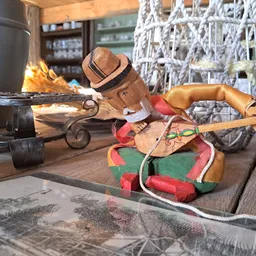 Diverse tweedehands voorwerpen op houten tafel, waaronder een houten vogel, skateboard en ander speelgoed