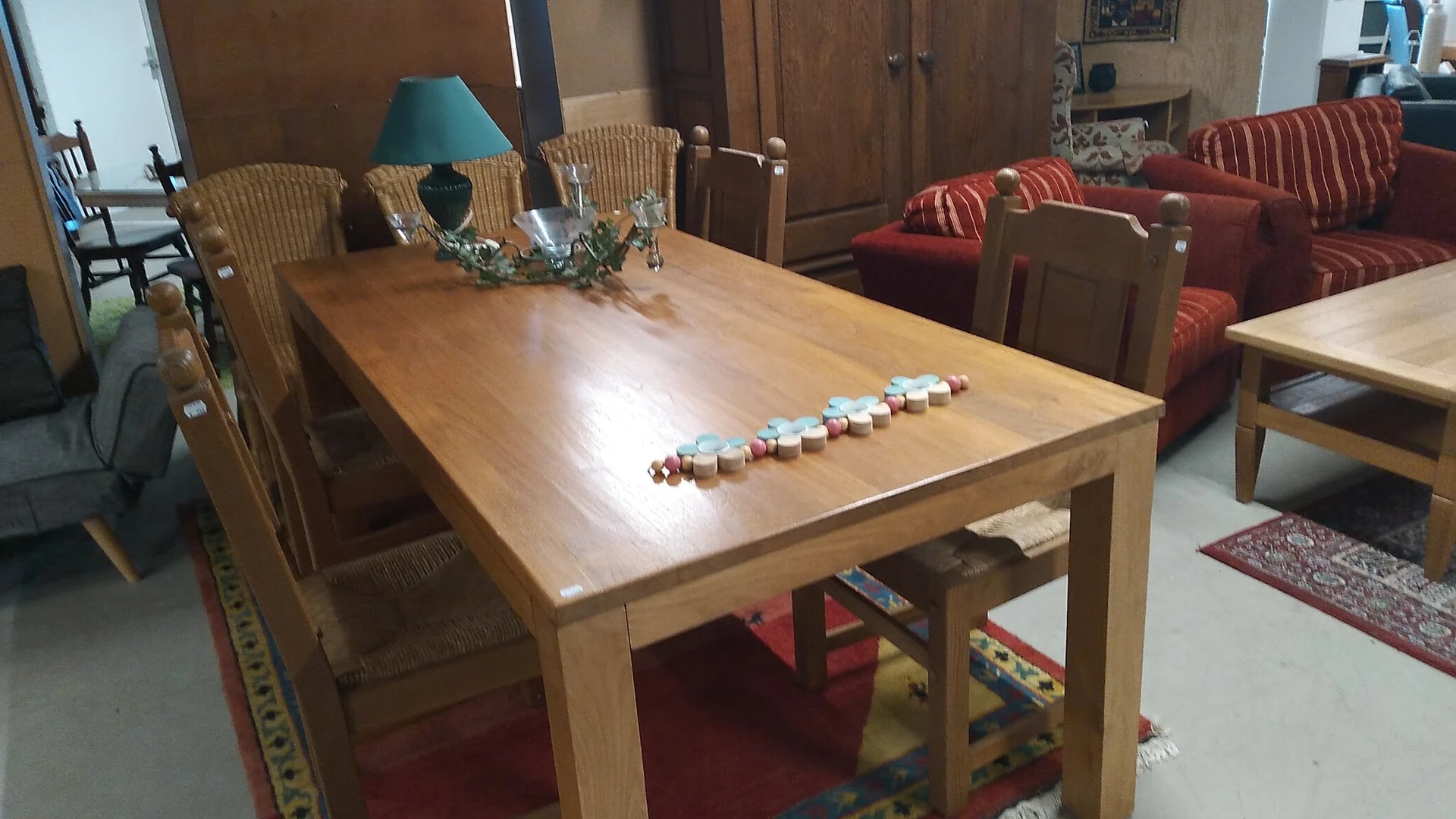 Houten eettafel met wicker stoelen en decoratieve objecten erop