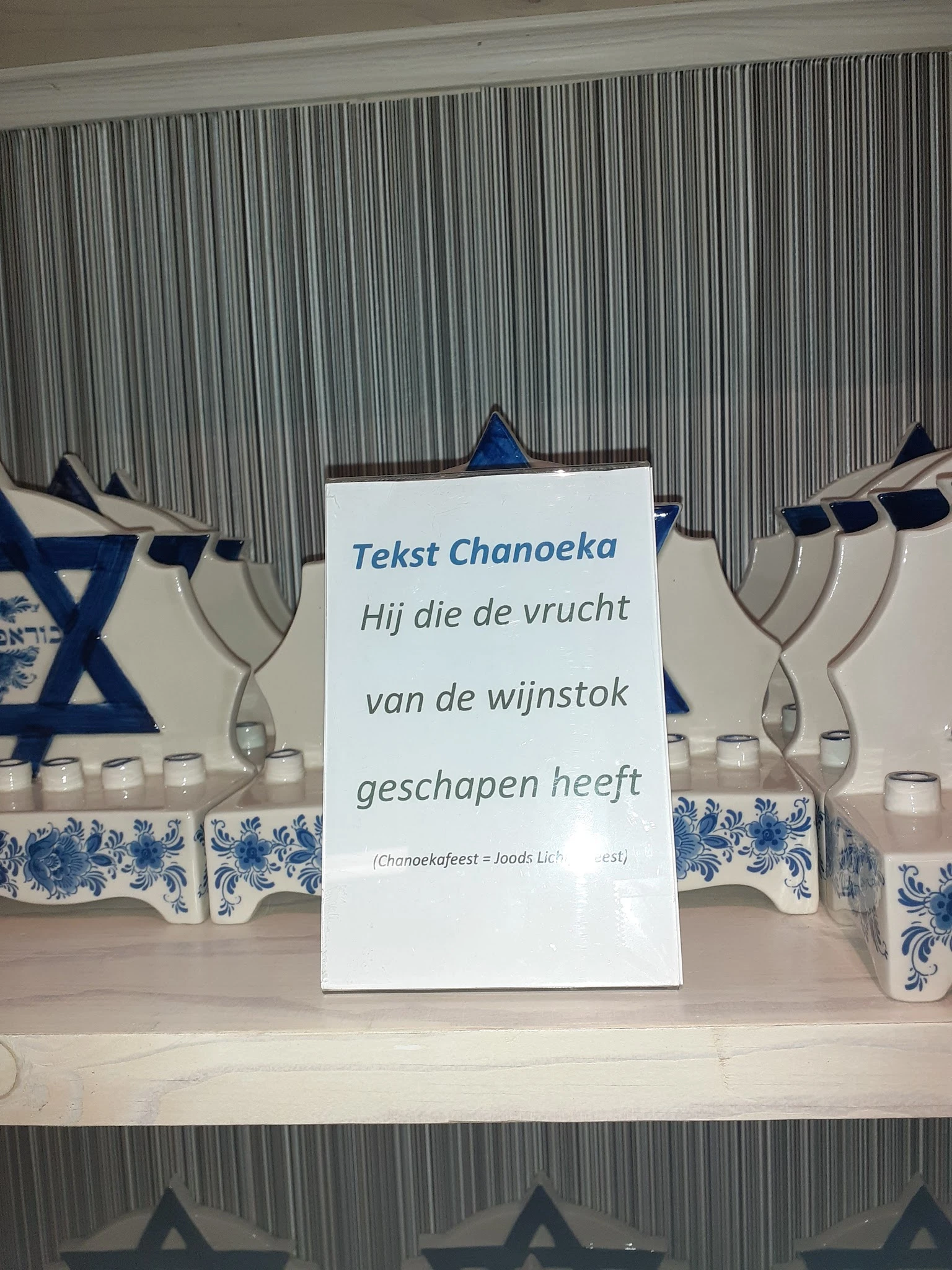 Displaykaart met Hebreeuwse tekst en Chanoeka-versieringen met kandelaars