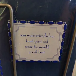 Tekstbordje met Nederlands spreukcitaat over vriendschap in decoratief frame