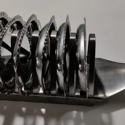 Close-up van een set metalen zaagbladen op een zwarte houder