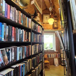Boekenkast met dvd's en boeken in vintage winkelinterieur met houten wanden en warm licht
