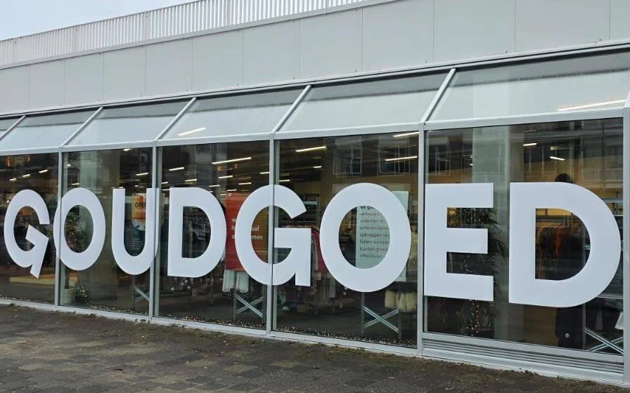 Winkelpui met grote witte letters van de winkelnaam op glazen voorgevel