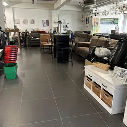 Winkelvloer van kringloopwinkel met meubels, fauteuils, stoelen en kasten uitgestald