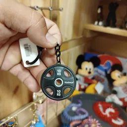 Sleutelhanger in vorm van schijf met gewichtsaanduidingen, met prijskaartje eraan