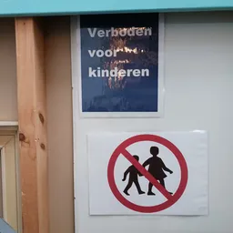 Waarschuwingsbord met verbodsteken en Nederlands tekstbord