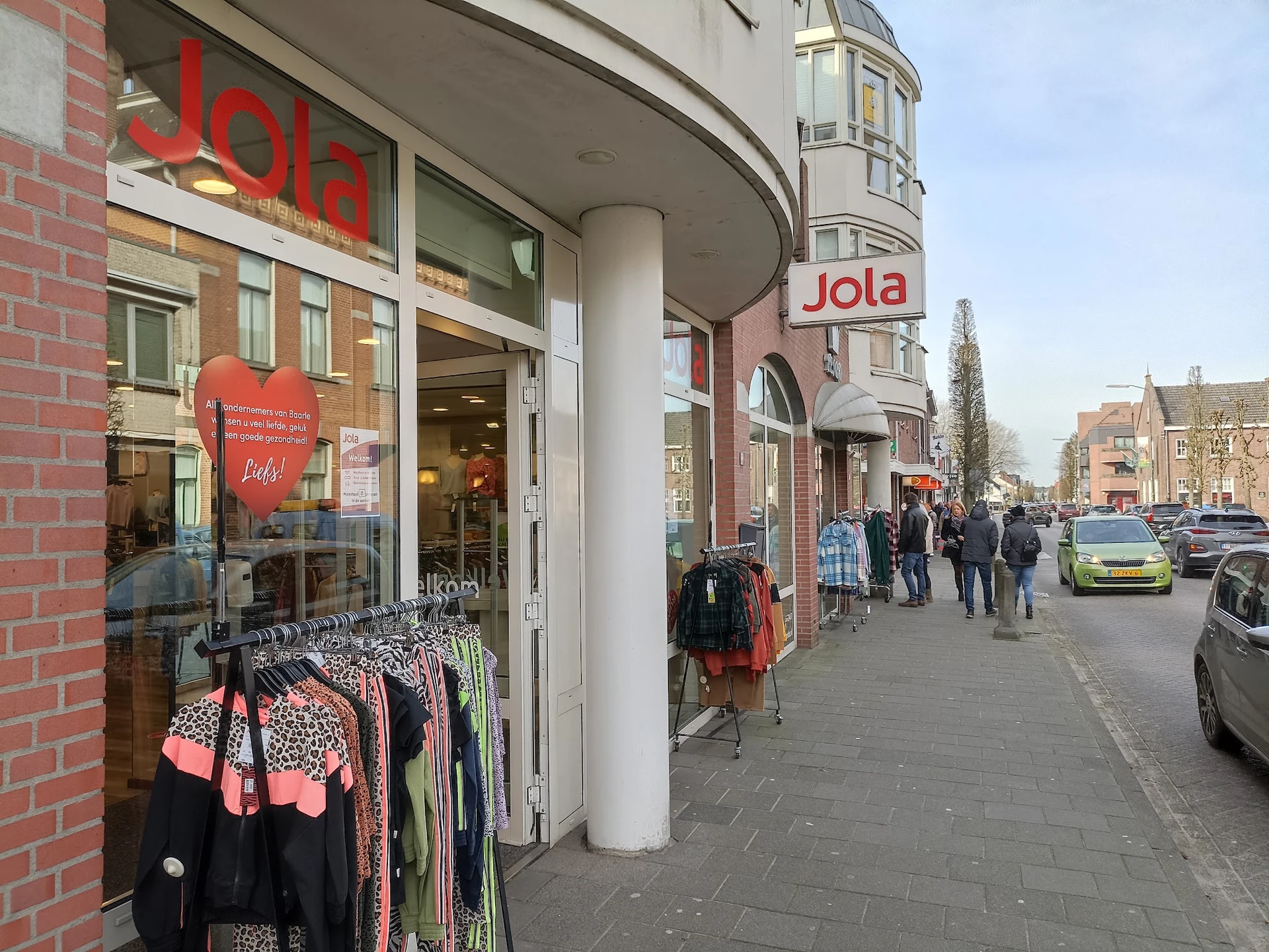 Gevel van kledingwinkel Jola aan een winkelstraat met etalage met kleding