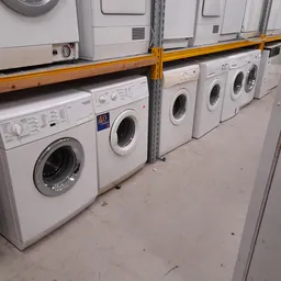 Rij wasmachines in verschillende modellen en kleuren uitgestald in de winkel