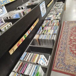 Rekken met CD's en DVD's uitgestald in een kringloopwinkel