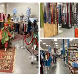 Overzicht van kringloopwinkel met kledingrekken, stellingen met boeken, decorstukken en uiteenstalling van tweedehands goeder