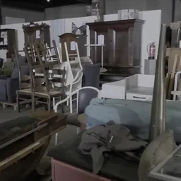 Winkelvloer met diverse meubels: stoelen, tafels en kasten uitgestald tussen rekken.