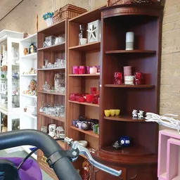 Houten stellingen met huishoudelijke artikelen, kaarsen, serviesgoed en decoratieobjecten