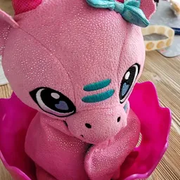 Roze pluchen speelgoedfiguur met glitters en grote ogen in close-up