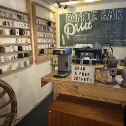 Koffiebar met espressomachine, leesbaar krijtbord met menu en promotie 'grab a free coffee'