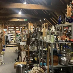 Winkelvloer met stellingen vol huishoudelijke artikelen, servies en decoratie