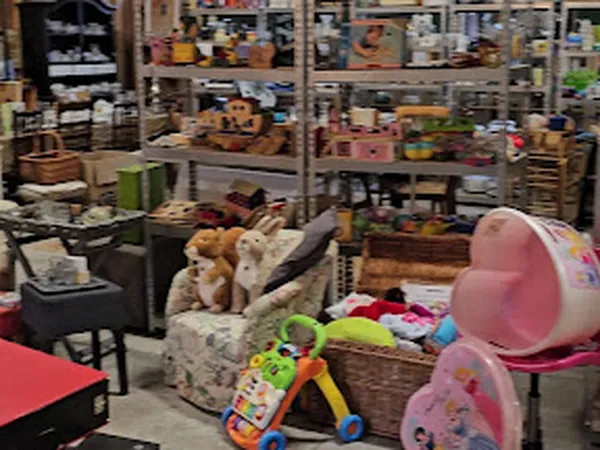 Winkelinterieur met speelgoed, knuffels, kinderkleertjes en meubelstukken op stellingen