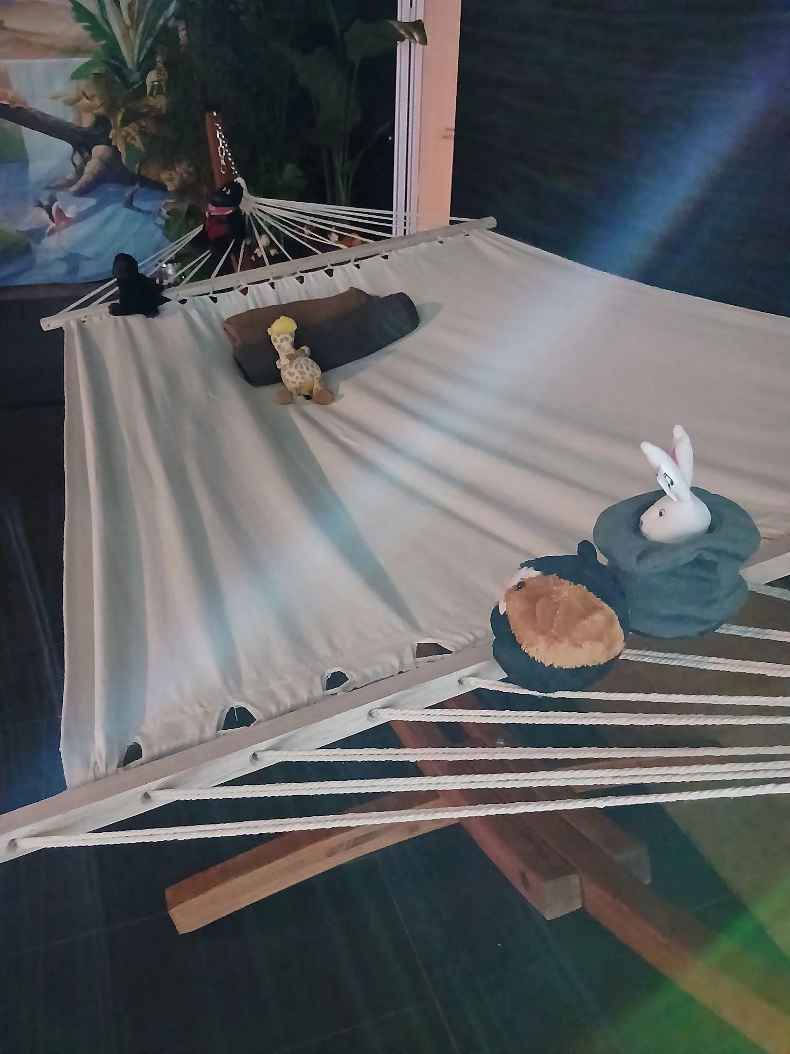 Hangmat met verschillende decoratieve items erop: knuffels, serviesgoed en textiel