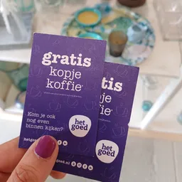 Paarse promotiefolder voor gratis kopje koffie van Het Goed kringloopwinkel