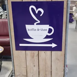 Bord met logo en tekst 'koffie & thee' met pijl, aanduiding van de lunchroom in de winkel