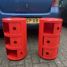 Twee rode kunststof opbergkasten met drie laden naast elkaar