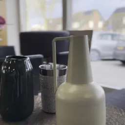 Close-up van glazen en kannen op een tafel in een winkelinterieur