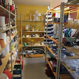 Winkelvloer met metalen stellingen vol huishoudartikelen, decoratie en textiel