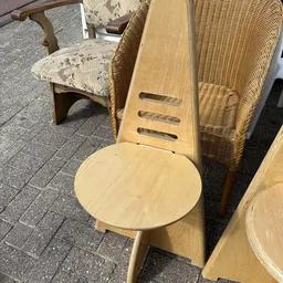 Tweedehands houten stoelen en rieten meubels uitgestald in de winkel