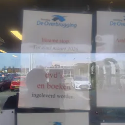 Gesloten winkel met een poster in het raam met tekst over sluiting