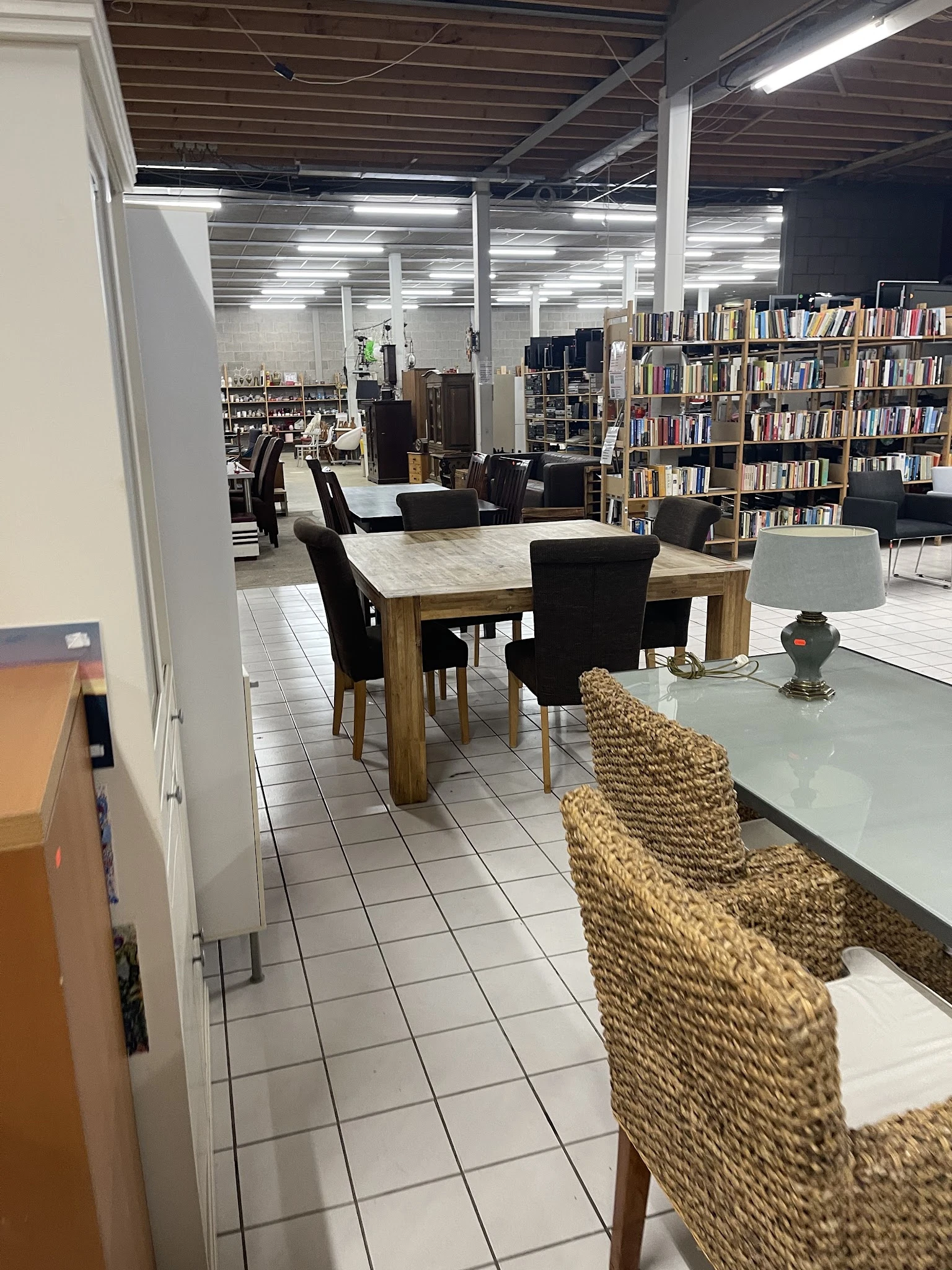 Winkelvloer met eettafel, stoelen, boekenkast en verschillende meubels en inrichtingsspullen