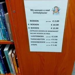 Prijsbord met aanbod en prijzen van boeken, tijdschriften, kinderboeken en strips