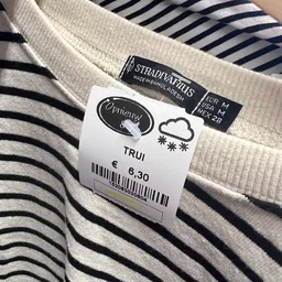 Prijssticker op kledingstuk met barcode, maat en prijs €6,30