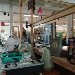 Winkelvloer met rekken, kasten en diverse gebruiksartikelen in een ruime kringloopwinkel
