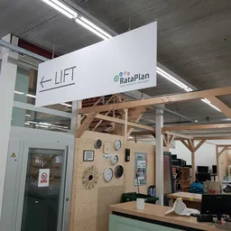 Winkelinterieur met houten constructie, klokken aan muur, RataPlan-bord en winkelomgeving