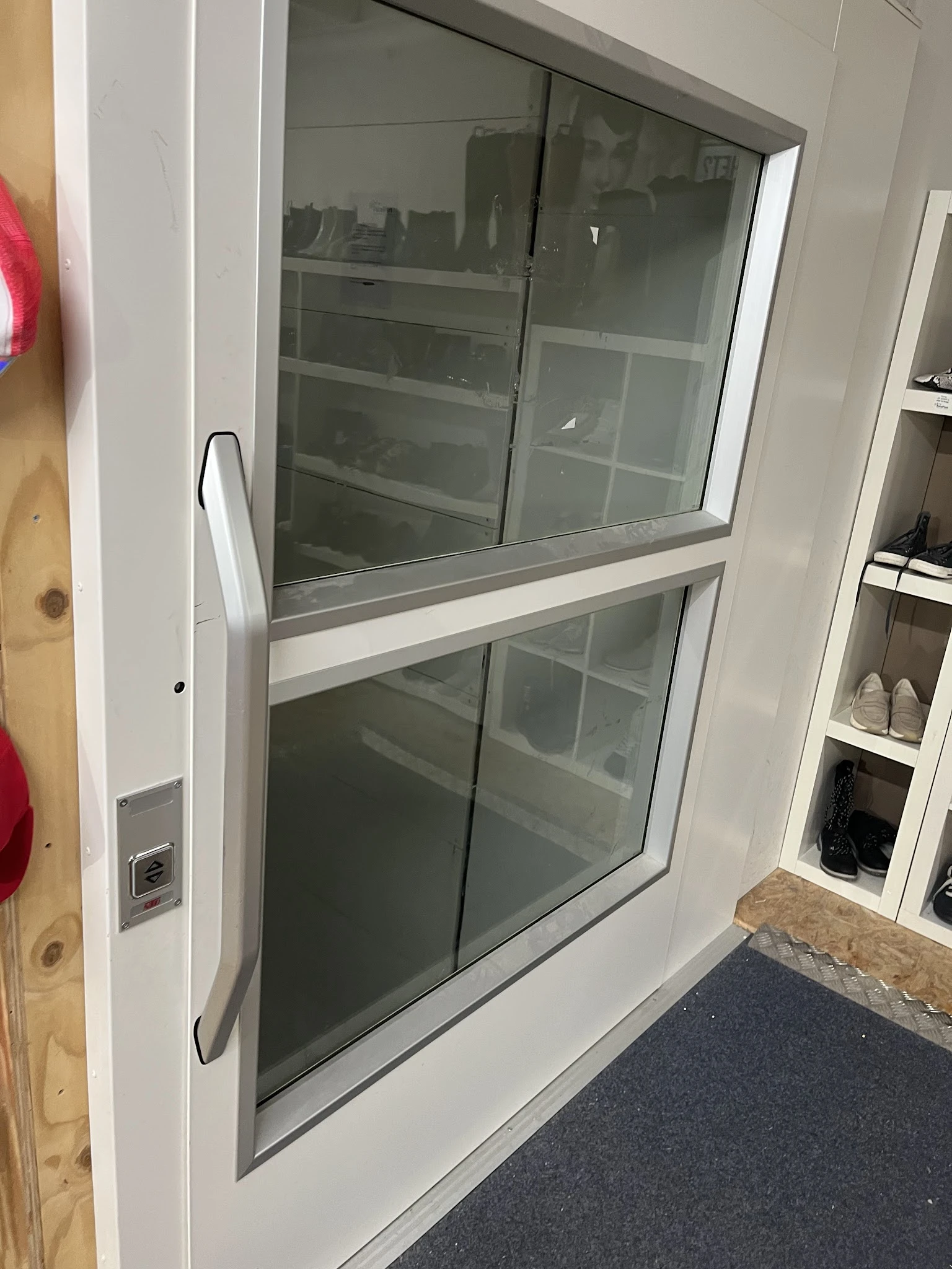 Witte kunststof schuifdeur met glazen panelen en aluminium frame in showroommodstelling