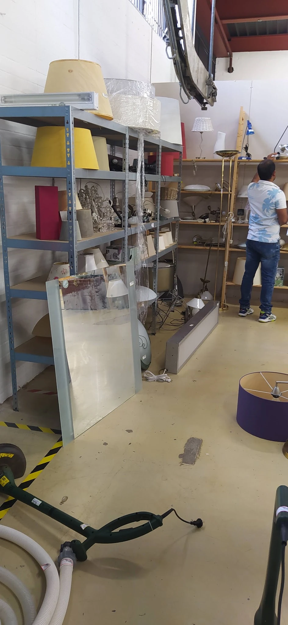 Winkelvloer met stellingen, dozen en apparatuur in een kringloopwinkel