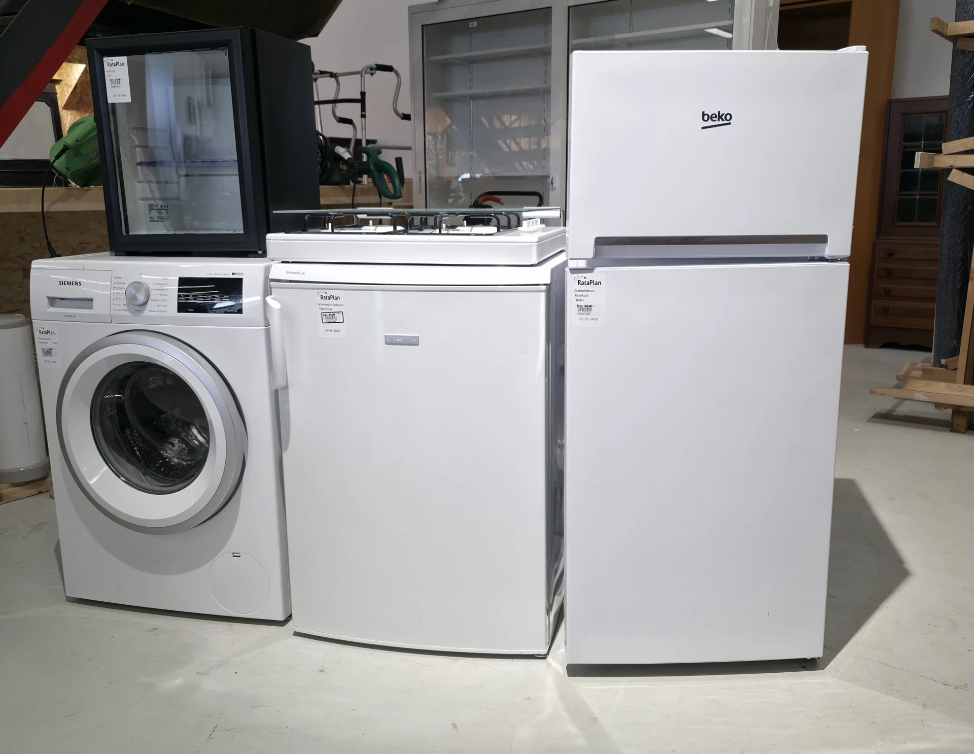 Witgoed in een kringloopwinkel: wasmachine, vaatwasser, gasfornuis en twee koelkasten