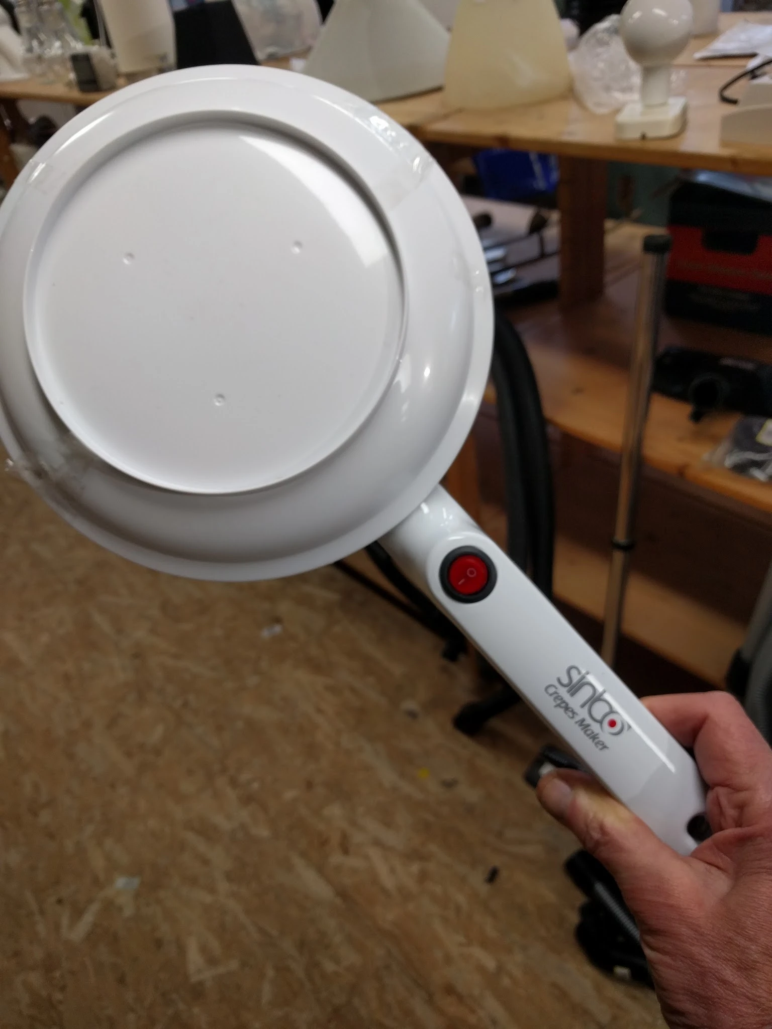 Close-up van een witte handheld-vergrootglas met rode aan/uit-knop