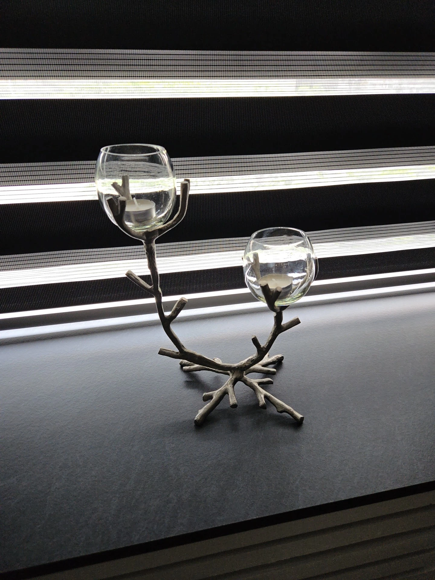Decoratief takkenstandaard met twee glazen kelken gevuld met water