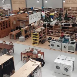 Overzicht van winkelvloer met huishoudelijke apparaten, meubels en stellingen