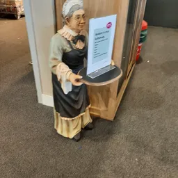 Decoratief beeldje van een vrouw in vintage kleding met dienblad