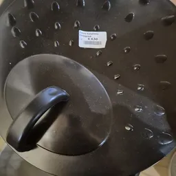 Grijze metalen saladeslinger met zwart handvat, op display met prijskaartje €4,50