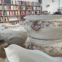 Tafelservies en schalen met bloemenpatroon uitgestald op tafel in de winkel