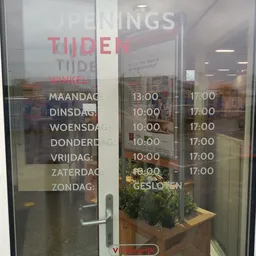 Openingstijden op glasdeur met dagen en uren in wit en rood